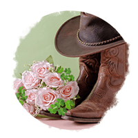 Bouquet of pink roses next to brown cowboy boots and a cowboy hat
