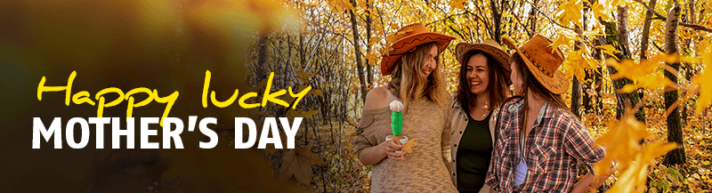 three happy women with cowboy hats one holding a blooming cactus