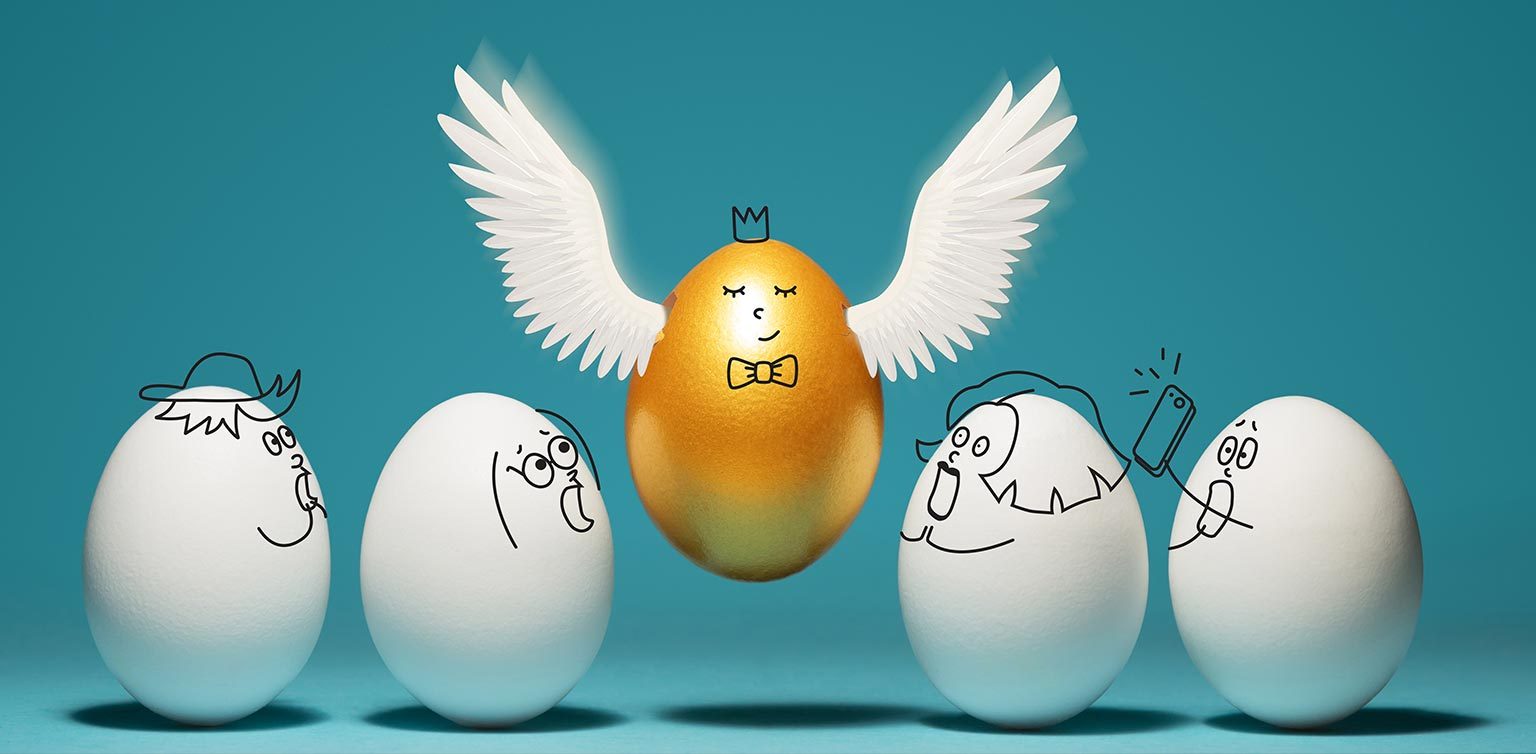 A photo of 4 white eggs with surprised expressions and a very contented golden egg with wings