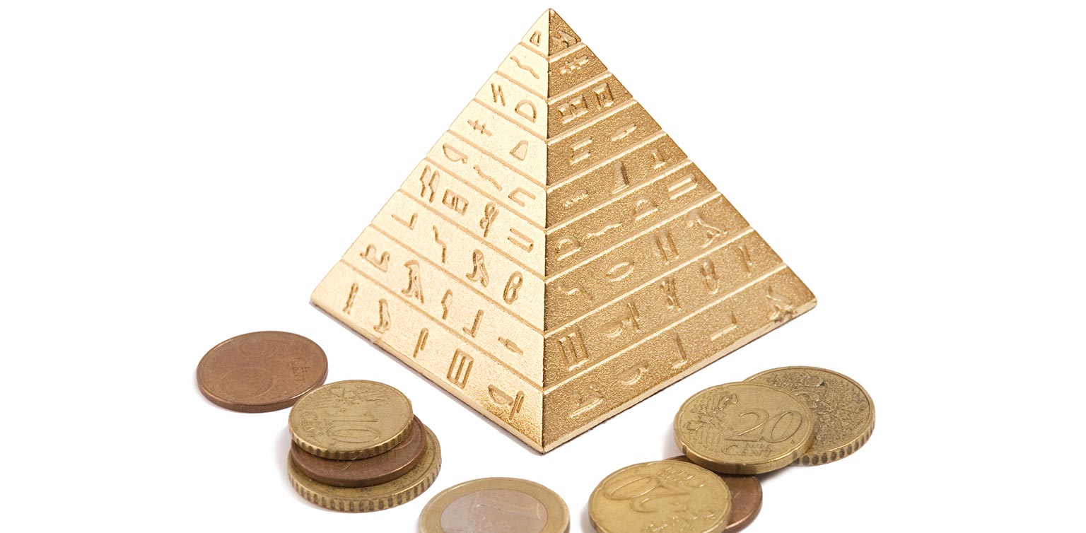 An image of a golden pyramid and coins isolated on white