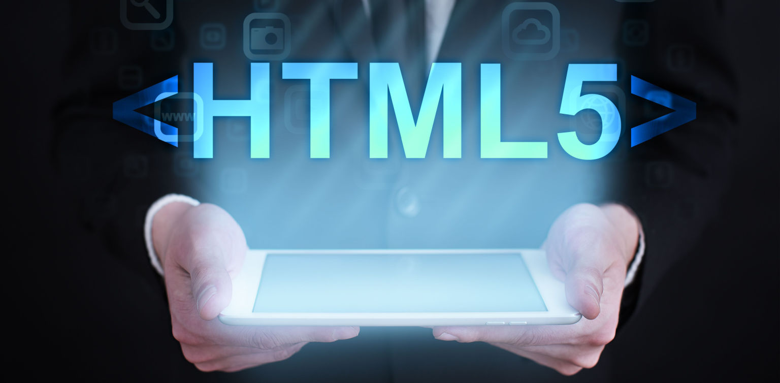 A photo of a man holding a tablet with two hands with HTML5 in bold blue letters above the screen on a dark background