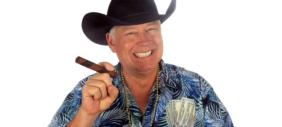 A photo of a smiling man wearing a Stetson holding a cigar and a wad of dollars isolated on white