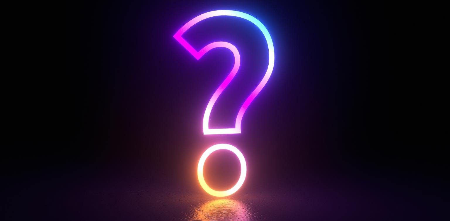 A question mark neon sign on a dark background