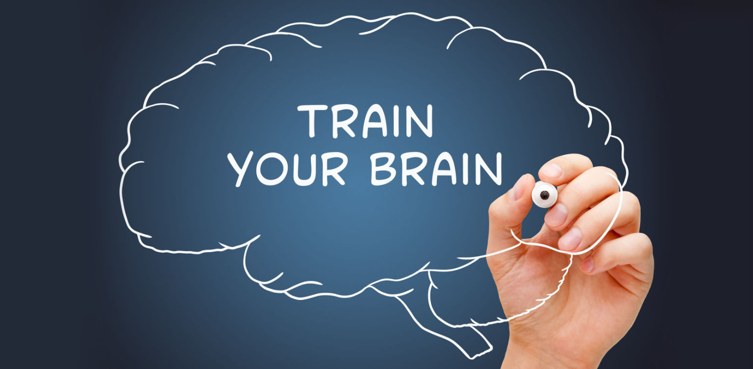 An image of a brain-shaped speech bubble with the words ‘train your brain’ and a hand holding a marker on a blue background