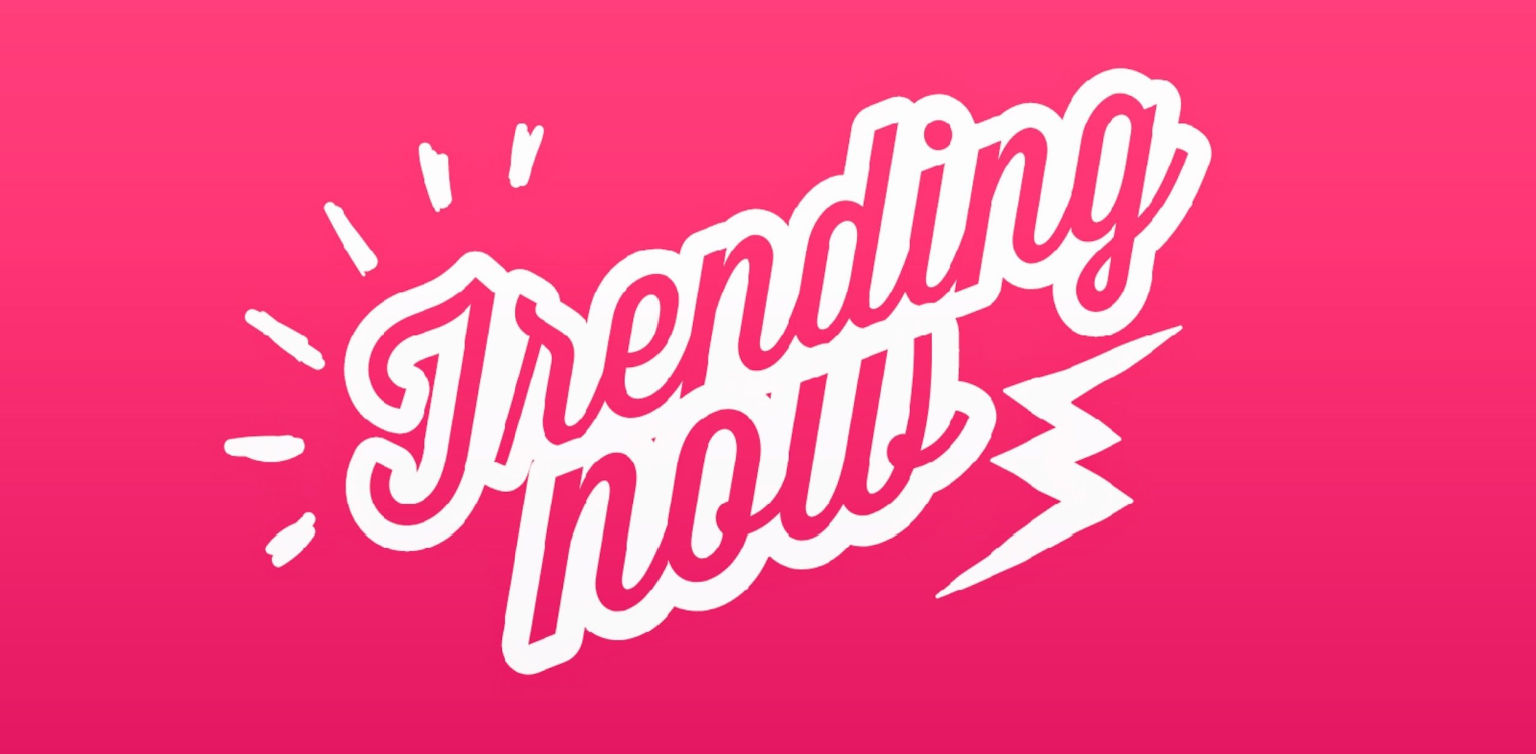 An illustration of “Trending Now” in white handwritten typography on a pink background