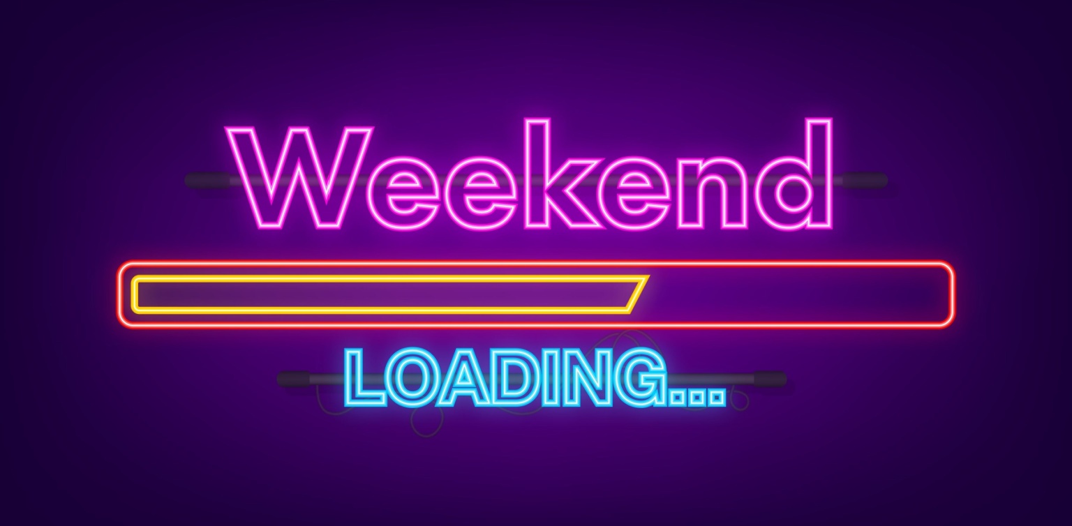 A colorful neon sign showing ‘weekend loading’ on a dark purple background