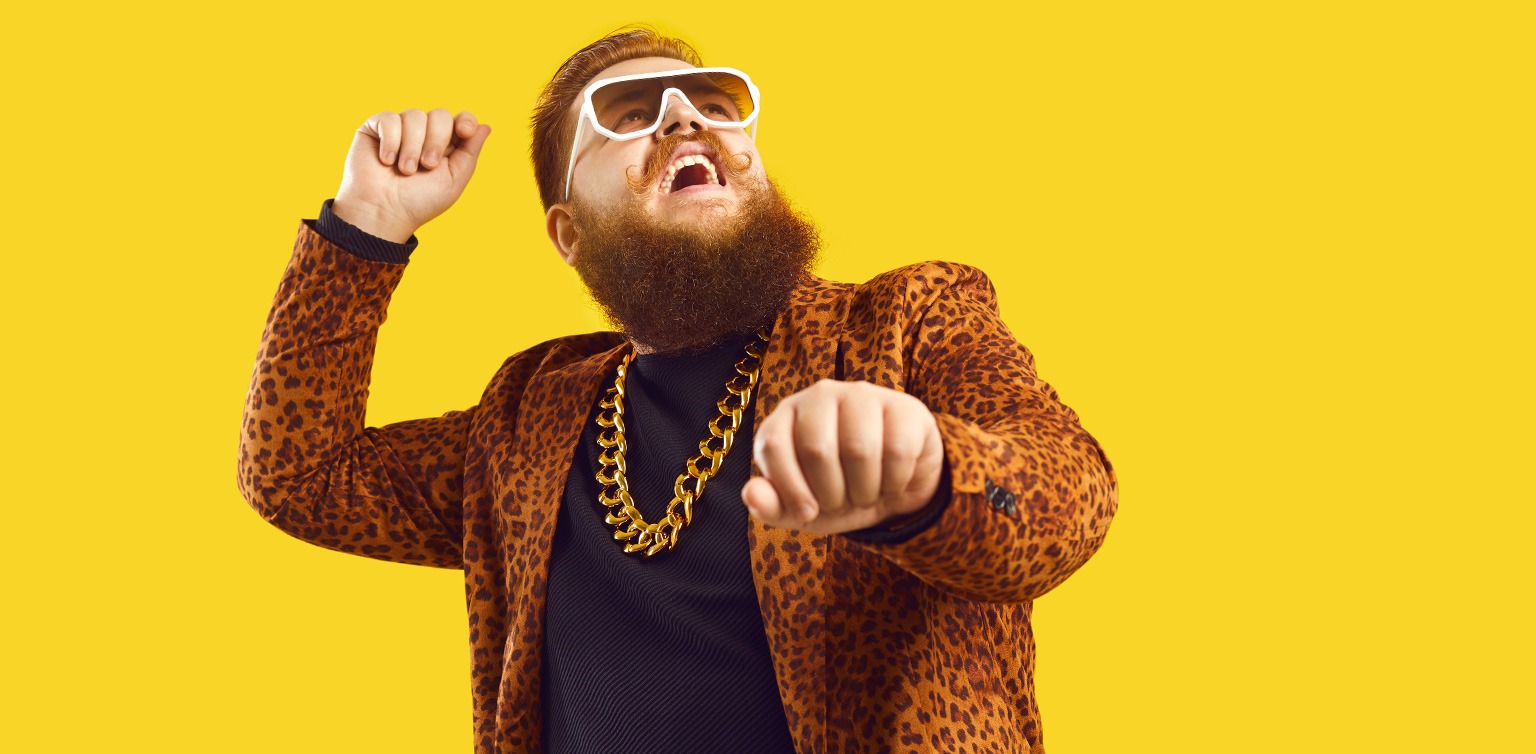 A photograph of a happy rapper dancing gangam style astride a make believe horse on a yellow background